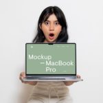 Free MacBook Pro Holding by Women Mockup-2